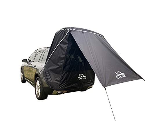 A HASIKA Tailgate Shade Awning Tent attached to a car.