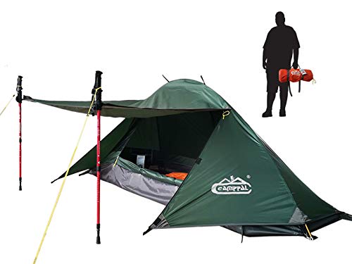 A man standing next to a camppal 1-person tent for camping and hiking with poles.