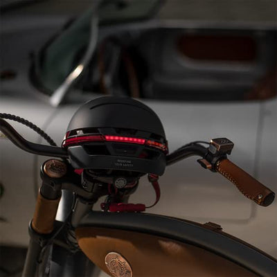 A close up of a Livall Neo Bluetooth Smart Bike Helmet on a bike from Livall Riding.