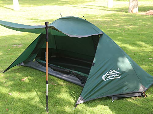 A Camppal 1-Person Tent Camping Hiking sitting on top of a lush green field.