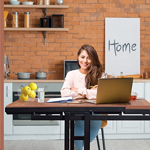 smiling woman sitting at the desk with computer and other items on the desk