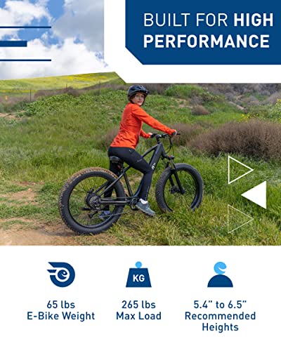 An image of a woman riding a Hiboy P6 Electric Bike for Adults, 28MPH 62.1Miles Range 750W Motor 48V 13Ah Removable Battery Ebike, 26” x 4.0" Fat Tire Electric Mountain Bicycle in a field.