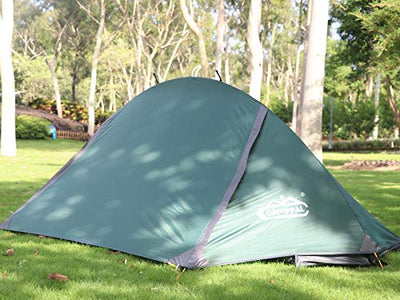 A camppal 1-person tent camping hiking sitting in the middle of a lush green field.