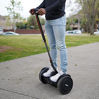 A man standing on a Segway Ninebot S-Max Smart Self-Balancing Electric Scooter.