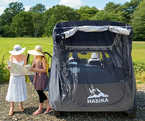 A couple of women standing next to a HASIKA Tailgate Shade Awning Tent for Car Camping Road Trip Essentials Midsize to Full Size SUV Van Waterproof 3000MM UPF 50+ Black (Large).