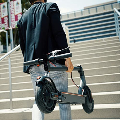 A man riding a Hiboy S2 Pro Electric Scooter with Seat, 500W Motor, 10" Solid Tires, 25 Miles Long-Range & 19 Mph Folding Commuter Electric Scooter for Adults with Dual Rear Suspension down a flight of stairs.