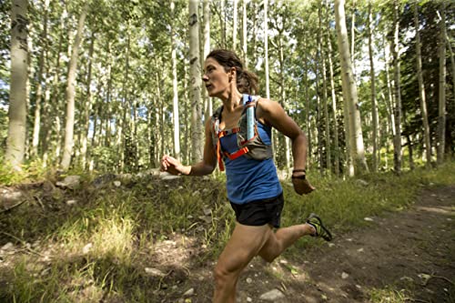 woman running down a wooded trail