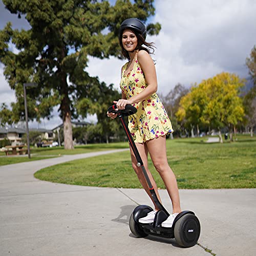 A woman riding a Segway Ninebot S-Max Smart Self-Balancing Electric Scooter in a park.