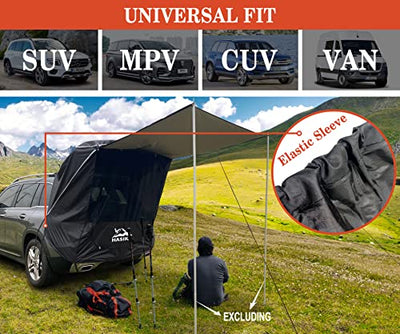 A man sitting in the grass next to a HASIKA Tailgate Shade Awning Tent for Car Camping Road Trip Essentials Midsize to Full Size SUV Van Waterproof 3000MM UPF 50+ Black (Large).