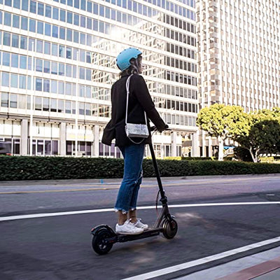 A woman riding a Hiboy S2 Pro Electric Scooter with Seat on a city street.