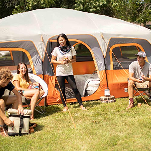 A group of people sitting outside of a CORE 12 Person Tent.