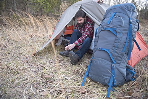 man inside tent with large backpack outside